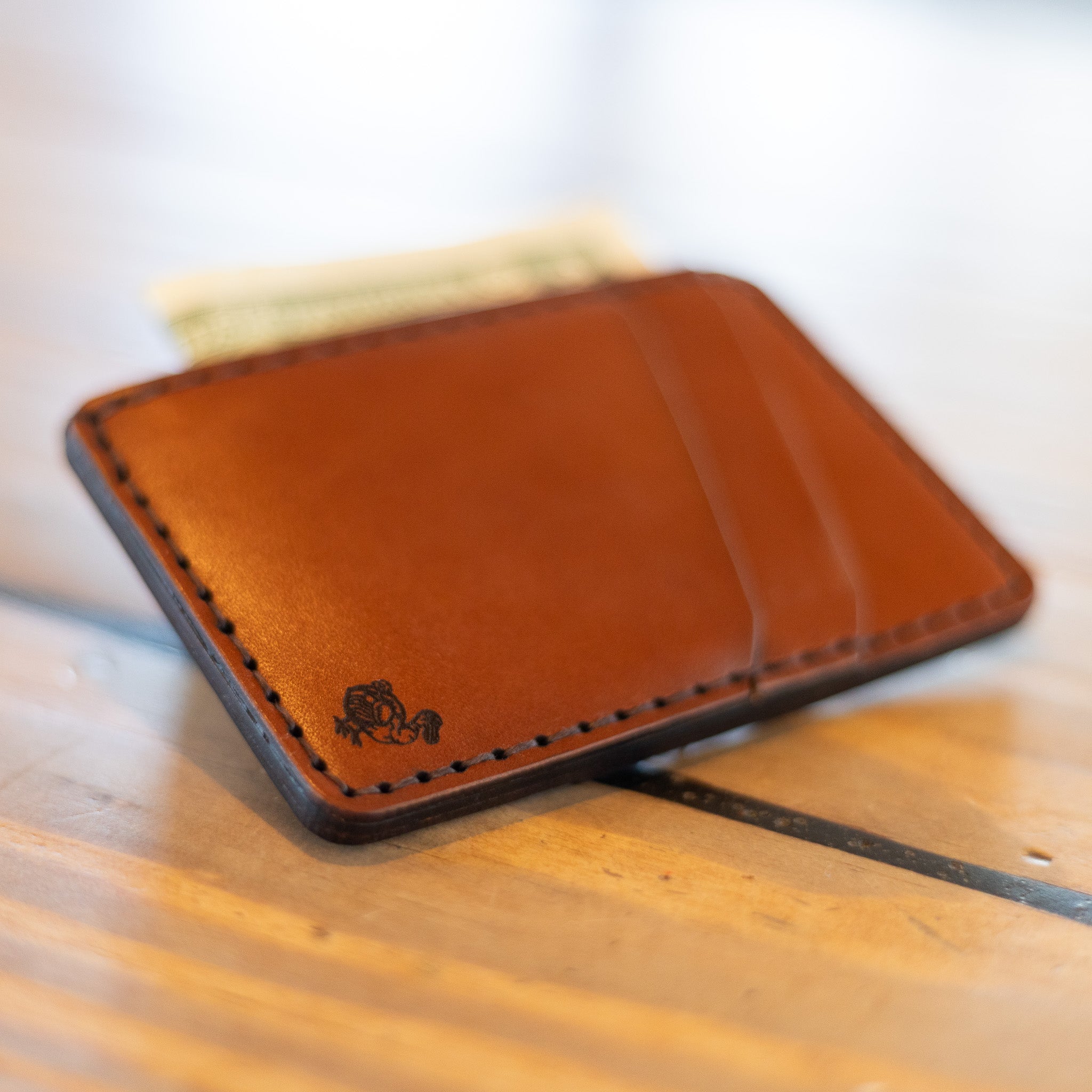 Front pocket wallet showing angled card pockets, chestnut leather