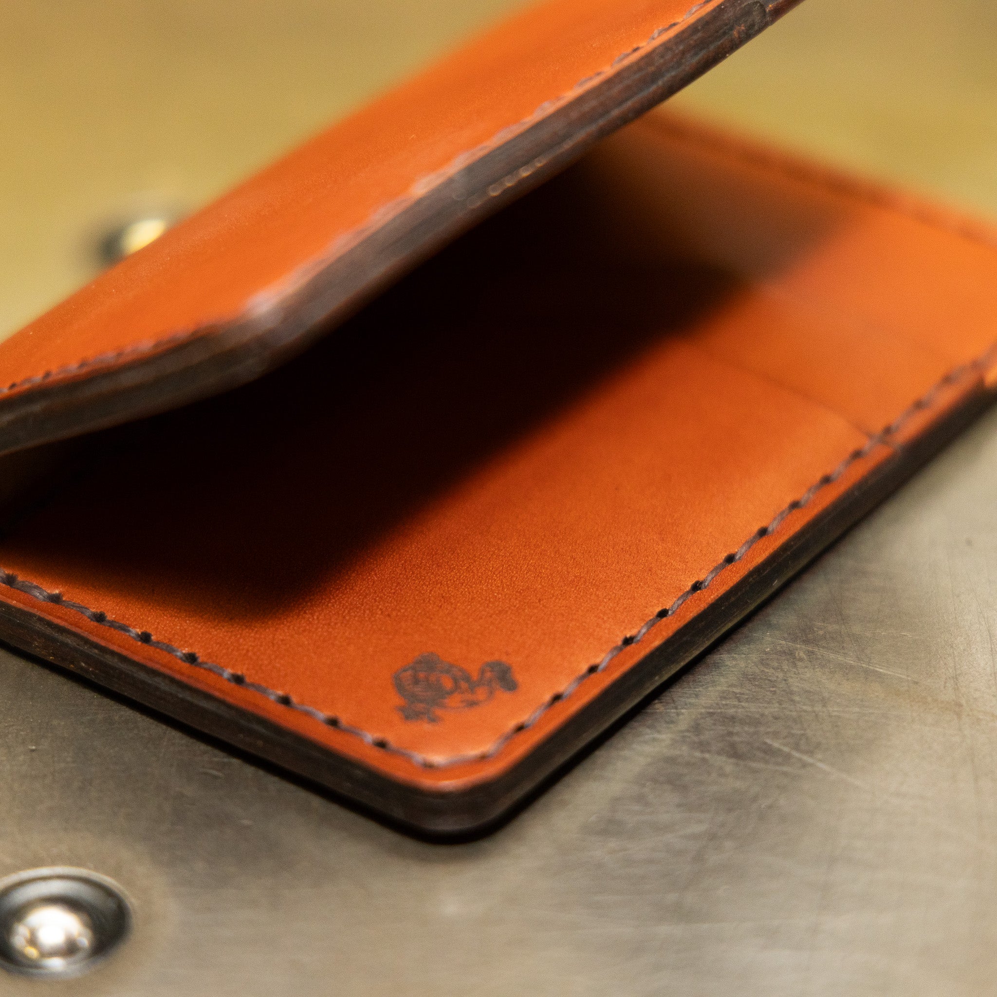 Slim vertical wallet open showing four vertical card pockets and tuck pockets