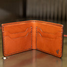 Handmade bifold wallet open showing card pockets and full-width bill compartment
