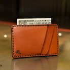 Front pocket wallet in chestnut English Bridle leather with cash in the bill slot, handmade in USA