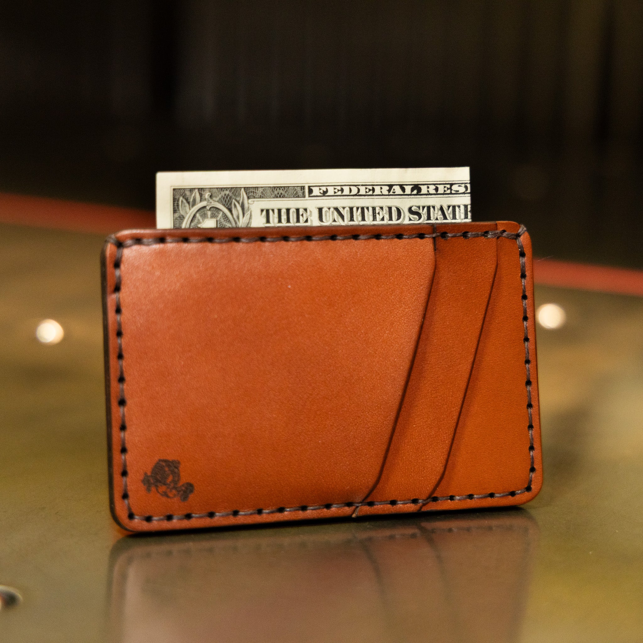 Front pocket wallet in chestnut English Bridle leather with cash in the bill slot, handmade in USA