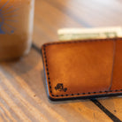 Slim front pocket wallet on coffee shop table with cash