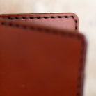 Macro close-up of English Bridle leather and hand stitching on bifold wallet
