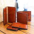 DODOcase English Bridle leather wallet collection styled on wood table — lifestyle