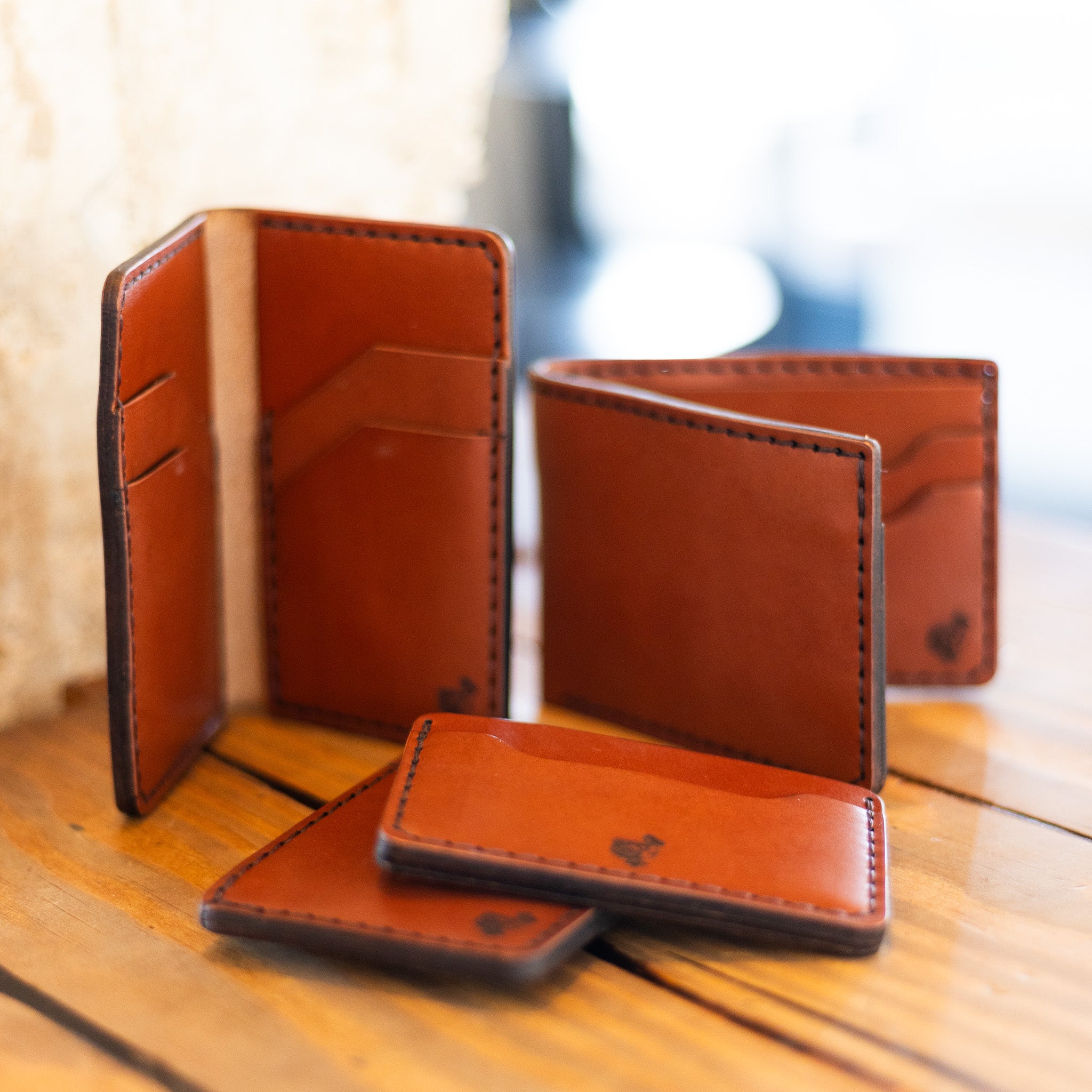 DODOcase English Bridle leather wallet collection styled on wood table — lifestyle