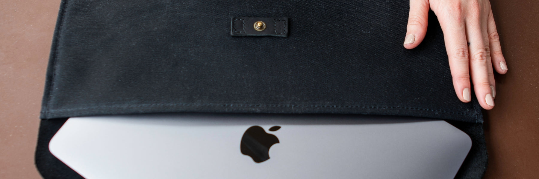 MacBook Sleeve in Black with computer coming out of the opening