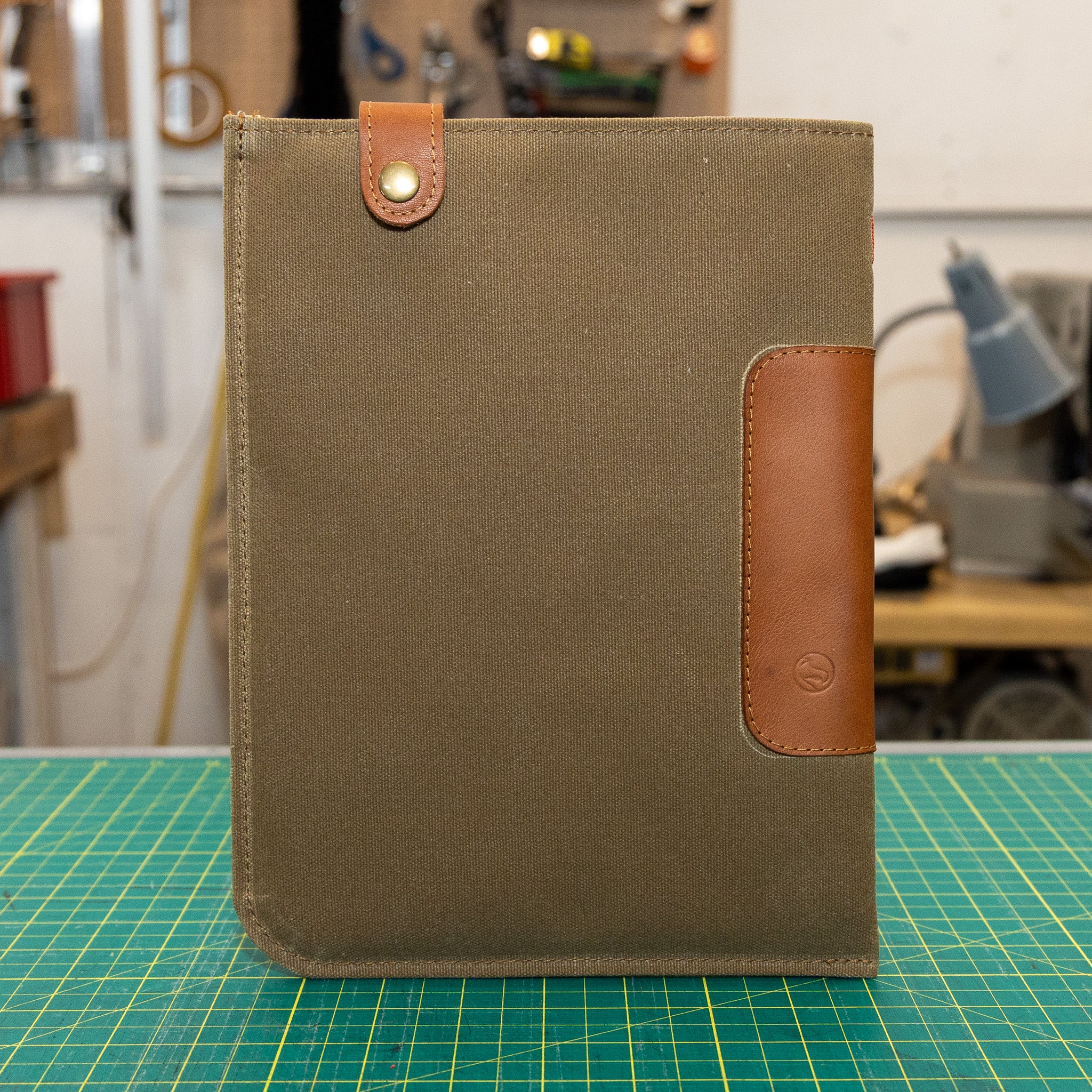 Tan iPad Sleeve with waxed canvas  on a green cutting mat